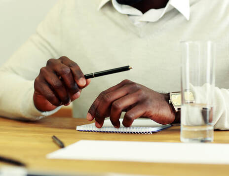 Man with pen and notepad, getting organized for business